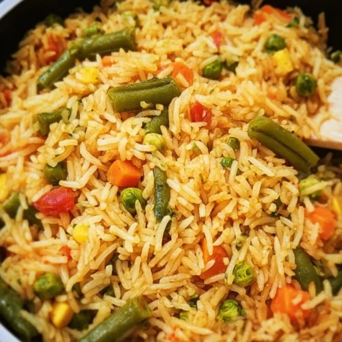 Bowl of colorful Mixed Vegetable Rice garnished with fresh herbs
