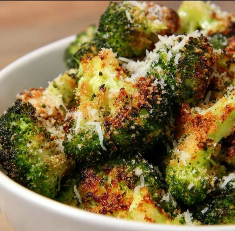 Baked Parmesan Crusted Broccoli garnished with seasoning in a serving dish