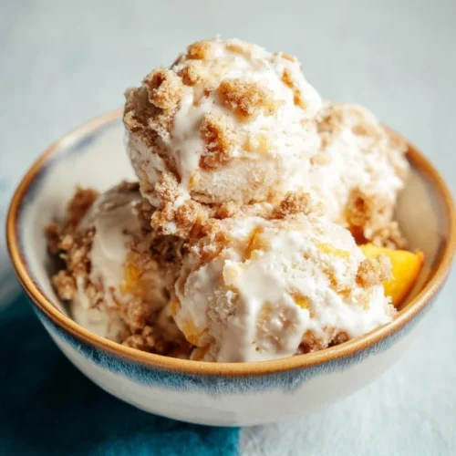 Delicious peach crumble ice cream with a crumbly topping