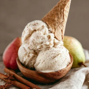 Spiced Autumn Pear Ice Cream in a bowl with cinnamon and nutmeg garnish