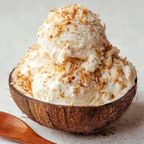 Toasted Coconut Crunch Ice Cream featuring a creamy coconut base and toasted coconut flakes.