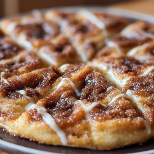 Delicious cinnamon-sugar pizza made with crescent rolls topped with cinnamon and sugar