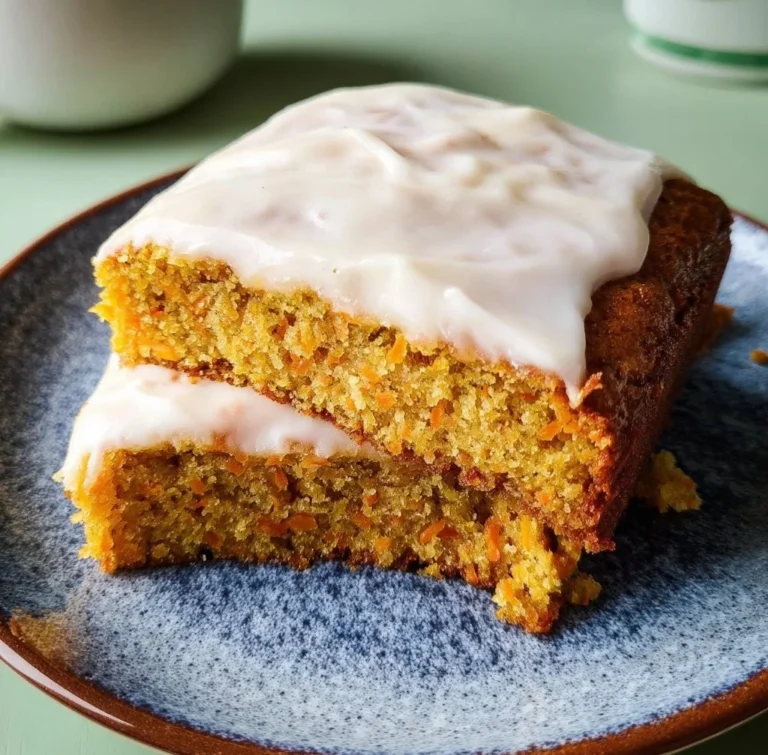 Delicious slice of cornmeal carrot cake topped with cream cheese frosting