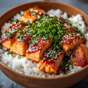 Crispy salmon rice bowl garnished with vegetables and sauces.