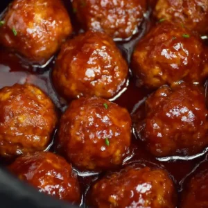 Crockpot BBQ grape jelly meatballs served in a bowl