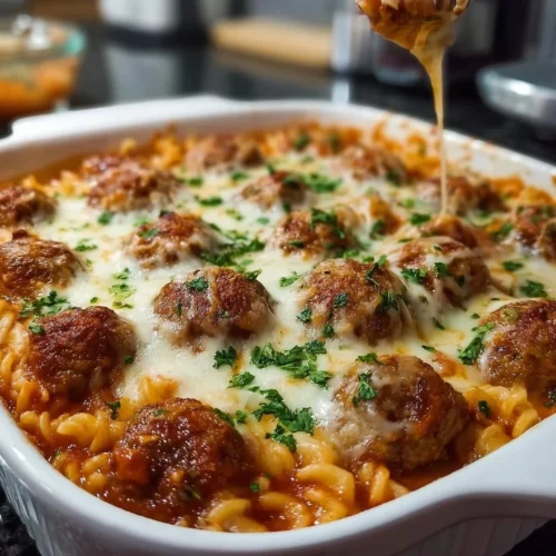 Delicious Dump and Bake Meatball Casserole topped with cheese and herbs