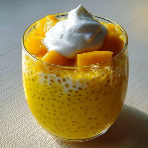 Bowl of easy Mango Sago dessert pudding with fresh mango slices and coconut milk