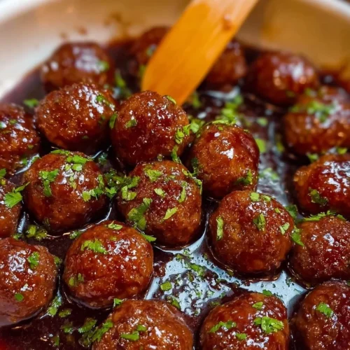 Plate of delicious grape jelly meatballs served as an appetizer.
