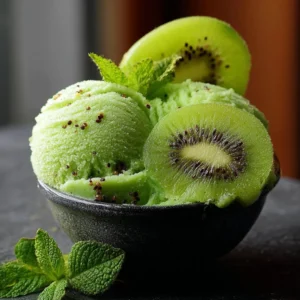 Bowl of vibrant kiwi sorbet garnished with fresh kiwi slices