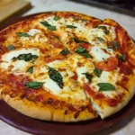 Delicious Margherita Pizza with fresh tomatoes, mozzarella cheese, and basil leaves.