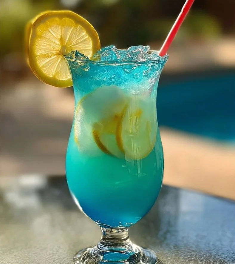 Colorful Mermaid Lemonade in a glass with vibrant hues of blue and pink.