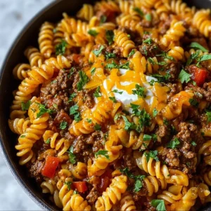 One Pot Beef Taco Pasta in a skillet topped with cheese and cilantro