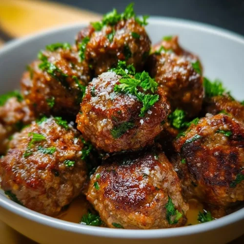 Tender Italian beef meatballs served in marinara sauce with herbs