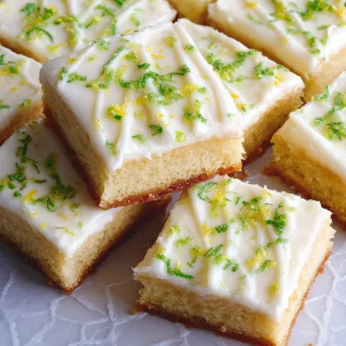 Zesty Lemon-Lime Frosted Sugar Cookie Bars Zesty lemon-lime sugar cookie bars with creamy frosting on a plate